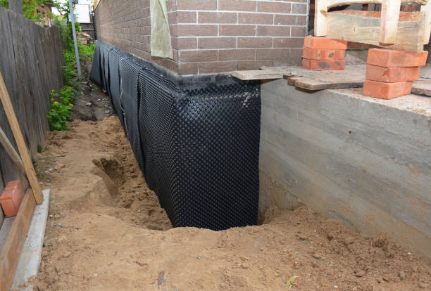 Happy homeowners after waterproofing job in Rutledge
